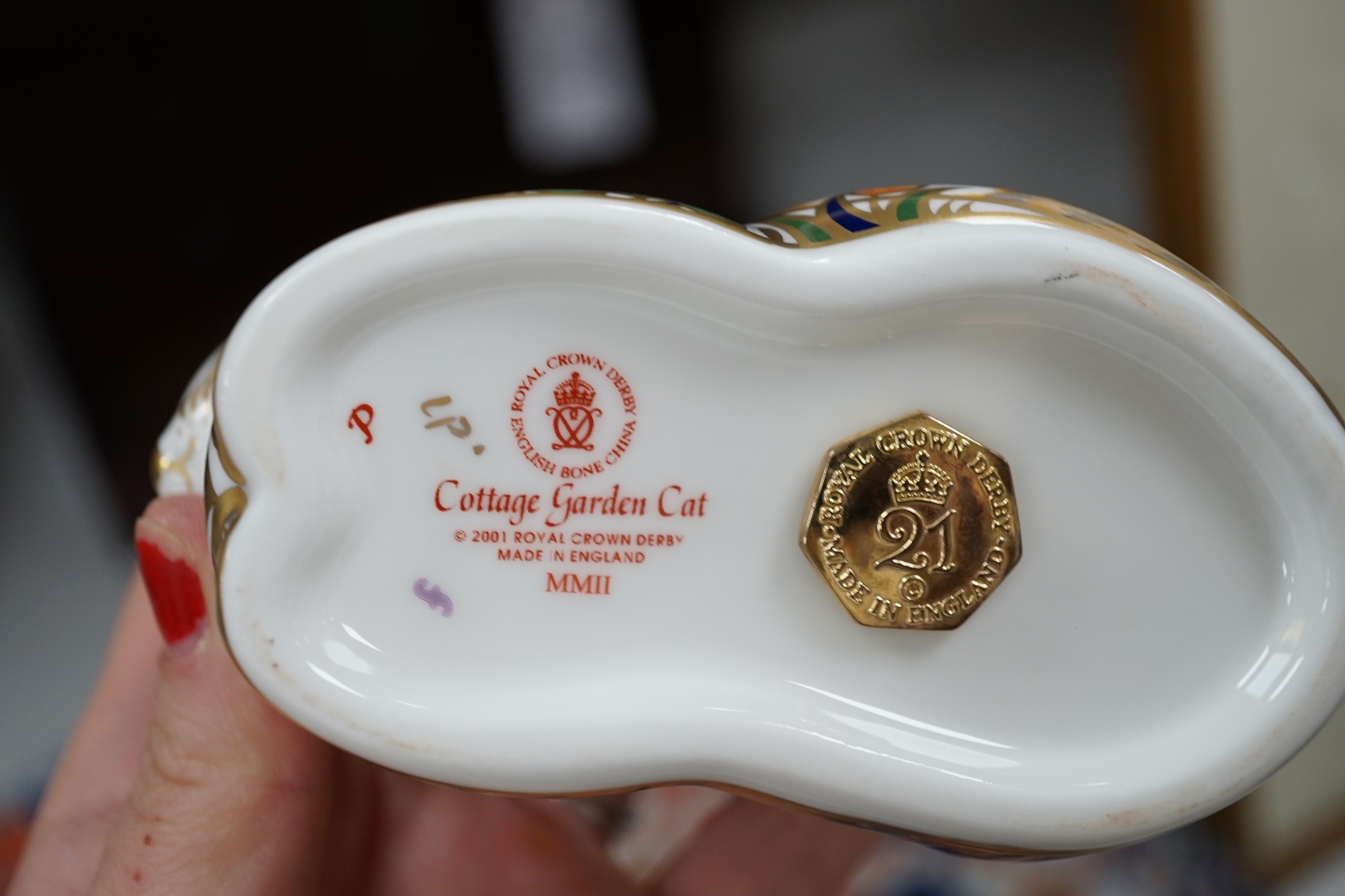 Approximately thirty-two Royal Crown Derby Imari porcelain paperweights, all but two with original boxes and mostly gold bottoms
